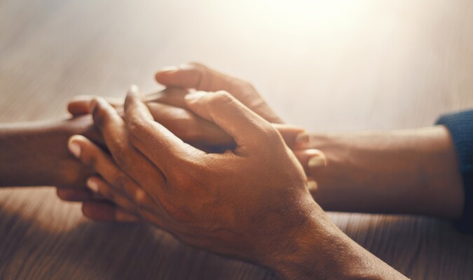 Two sets of hands embraced.