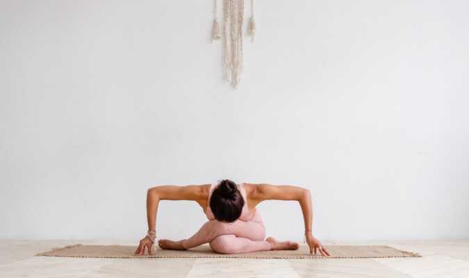 A person stretching on a yoga mat.