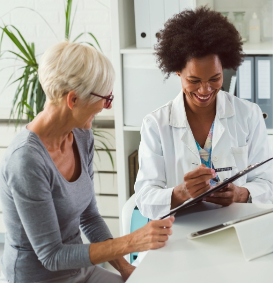 A patient speaking with a smiling provider.