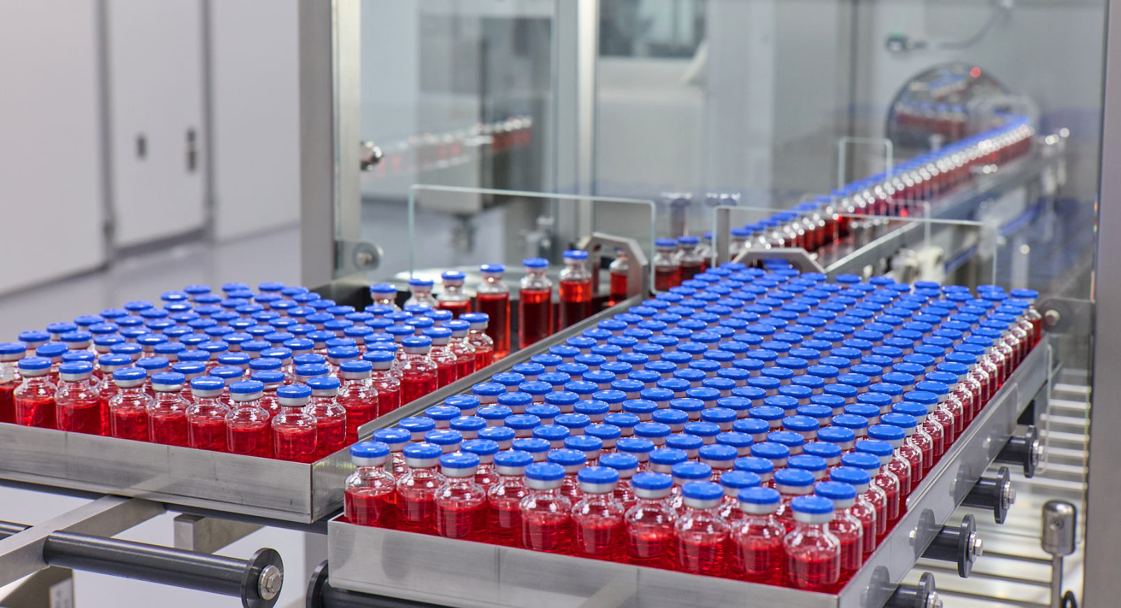 Two trays full of vials of liquid.